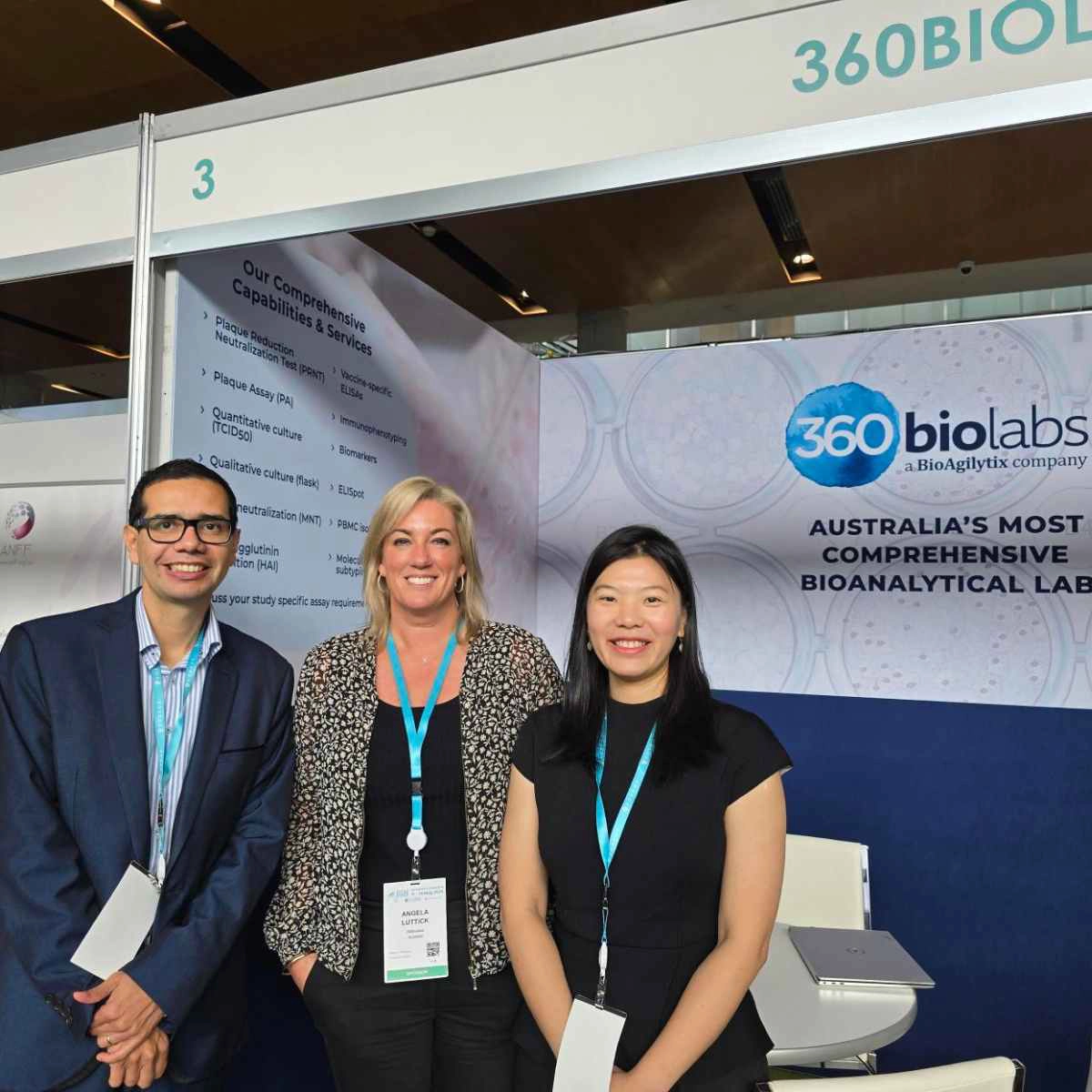 3 team members in front of event booth